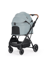 A stylish green pet stroller with a cozy enclosed canopy and mesh panels for ventilation, paired with a sleek black frame and brown leather handle.