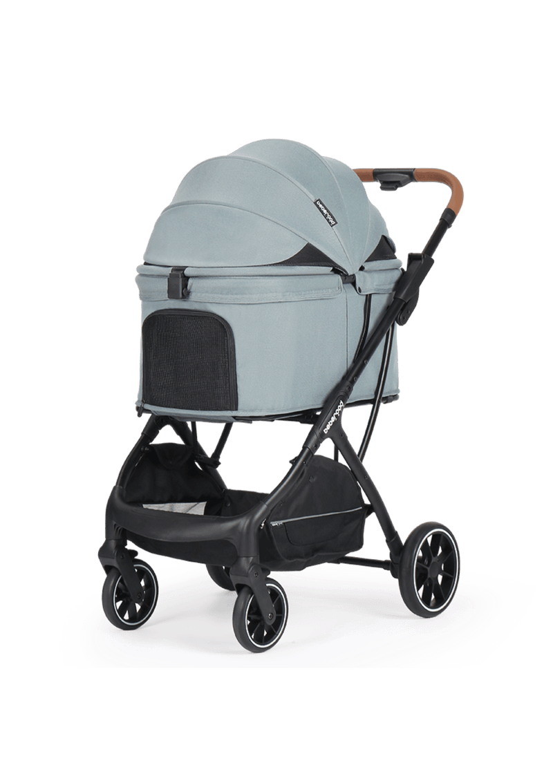 A stylish green pet stroller with a cozy enclosed canopy and mesh panels for ventilation, paired with a sleek black frame and brown leather handle.