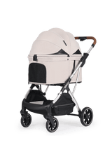 A minimalist beige pet stroller with an enclosed canopy and mesh ventilation panels, supported by a sturdy silver frame and brown leather handle for a refined look.