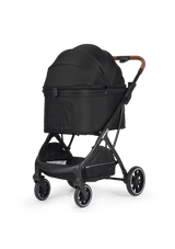 A chic black pet stroller featuring a closed canopy with mesh ventilation, a spacious storage basket underneath, and an elegant brown leather handle.